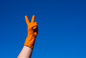 Hand in orazhevoy glove, a gesture against the blue sky.