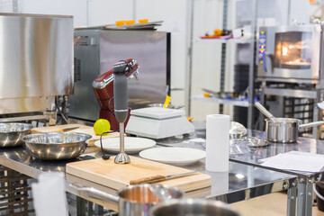 Professional chef, baker workplace with modern kitchen stand food mixer and board on table at cuisine of restaurant, bakery. Cooking, catering, culinary, gastronomy and food concept