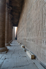 Columns and hieroglyphics outside the Edfu temple at sunrise