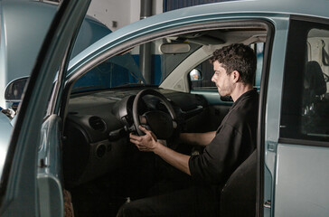 Mechanic doing tests inside the car