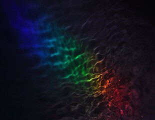 Illustration , abstraction, images of restless water illuminated by multicolored lights.