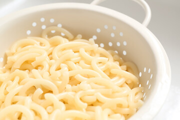 Colander with boiled pasta, closeup