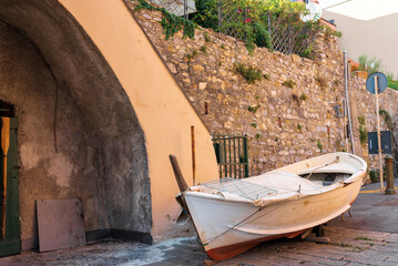 Fototapeta na wymiar Authentic fishing boat in old mariners village Boccadasse, Italy. Summer travel vacation background