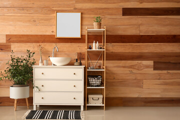 Interior of bathroom with ceramic sink, drawers and shelving unit