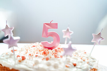 Big pink 5 number candle on homemade cake. Creative congratulations on five years for child girl. Festive decoration for 5th birthday, topping, dressing. Merry home holiday, party with mom, family