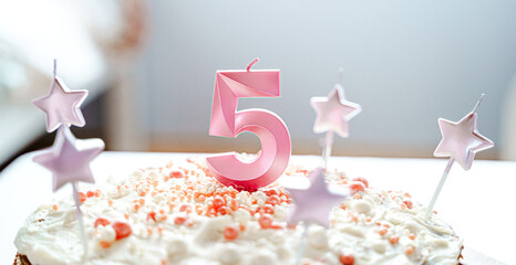 Big pink 5 number candle on homemade cake. Creative congratulations on five years for child girl....