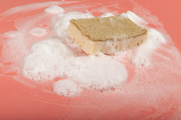 Natural Soapy Sponge with Foam, Eco Brown Sponges, Eco Friendly Hygiene Accessory on Pink Background