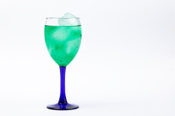 Green liquor glass on white background.