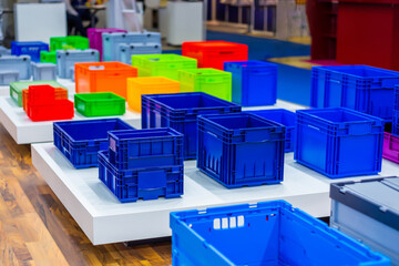 Many colorful plastic boxes, containers, crates at storage, warehouse, exhibition. Recycling, trade and logistic concept