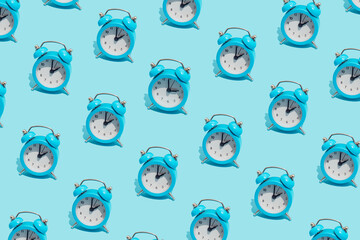Seamless pattern of blue retro alarm clocks  show 2 o'clock and one shows 3. Changing clock from...