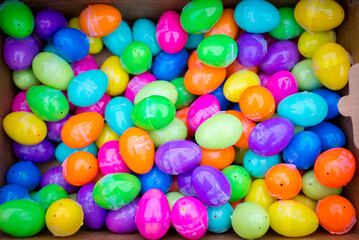 Fototapeta na wymiar Box full of colorful easter egg treats in a plastic egg shell for children