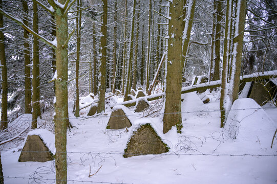 Anti tank wall or dragon's teeth on the Westwall covered in snow in a forest 