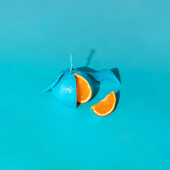 Monochromatic food concept. Tangerines on pastel light blue background. Minimalistic fruit composition. Creative summer nature idea.