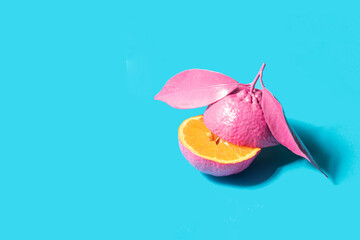 Modern food concept. Tangerine on light blue background. Minimalistic fruit composition. Creative summer nature idea.