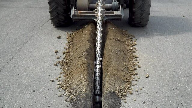 Asphalt cutting machine, metal saw cuts through asphalt and makes a groove or trench, road repair, special machinery work