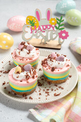Easter mini cheesecakes with candy eggs and whipped cream.