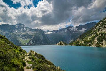 Fototapeta na wymiar Walking trail around beautiful Gelmersee lake in Switzerland
