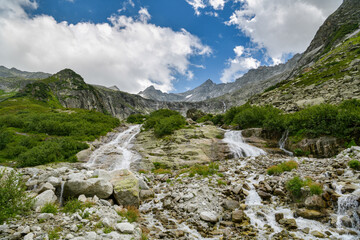 Small waterfall close to Gelmersee lake near Grimselpass in Switzerland