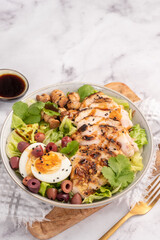 Green salad with baked chicken breast