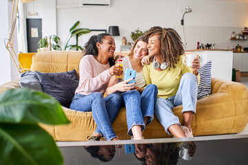 Indoor happy woman lifestyle portrait of three funny young female friends have fun and pretending...