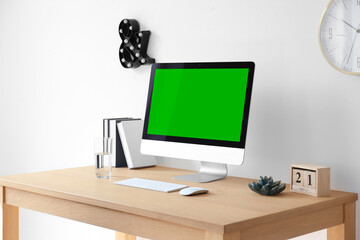 Computer display with chroma key on desk in room. Comfortable workplace