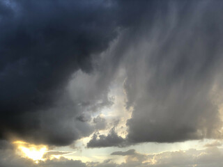 Black clouds at sunset and sun rays