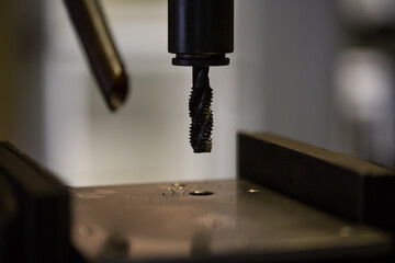 Thread cutting work with a tapping drilling machine