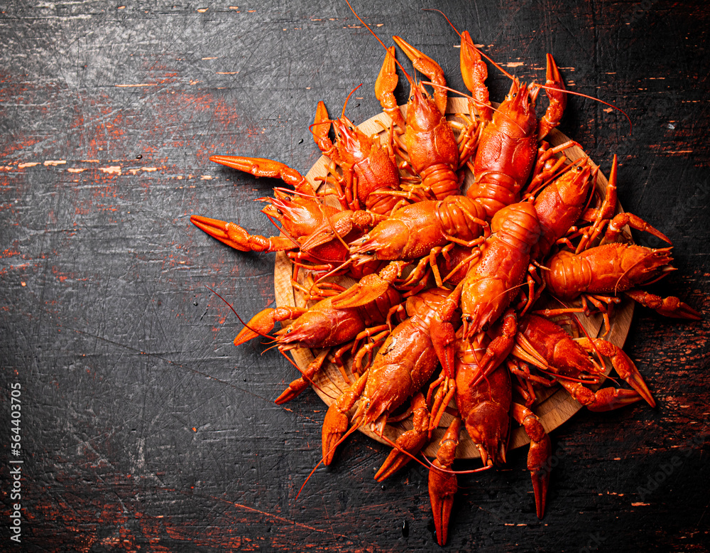 Sticker Boiled crayfish on a round cutting board. 