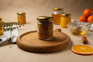 A bowl of honey. A beautiful female hand takes a honey dipper on a background of kraft paper.