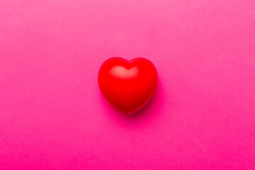 red heart shape on colored background. minimal concept top view with copy space
