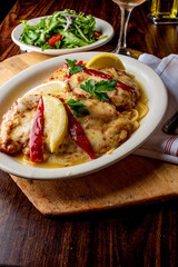 Chicken parmigiana. Traditional Italian comfort dish. Chicken breast covered in breadcrumbs fried, topped with marinara sauce, melted mozzarella, parmigiana and provolone cheeses and Italian parsley. 