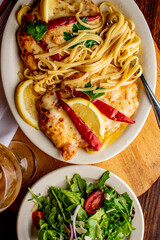 Chicken Parmesan or parmigiana. Italian comfort dish. Chicken breast covered in breadcrumbs fried, topped with marinara sauce, melted mozzarella, parmigiana and provolone cheeses and Italian parsley. 