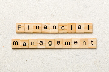 Financial Management word written on wood block. Financial Management text on cement table for your desing, concept