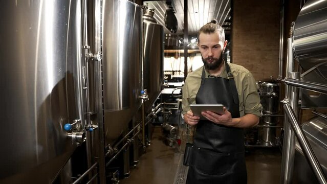 The male brewer controls the fermentation process and the temperature in tanks