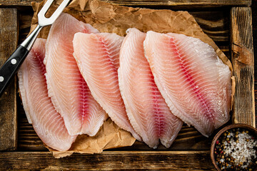 Delicious raw fish fillet on a wooden tray. 