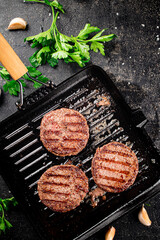 Grilled burger in a frying pan. 