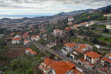 Fototapeta na wymiar View from a height on the slopes of the island of Madeira with houses.