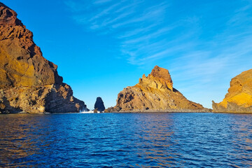Fototapeta na wymiar The rocks of an island in the Atlantic Ocean. Rocks stick out of the water.