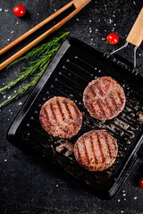 Grilled burger in a frying pan. 