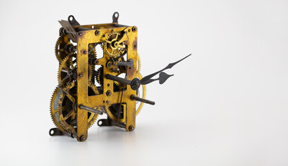 History concept. Old brass gears of a clock mechanism, on neutral white background. 