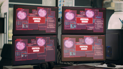 IT office displaying critical error message flashing on screen, multiple monitors showing security breach warning and system crash. Hacking attack alert and computer malfunction.