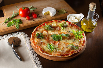 Obraz na płótnie Canvas appetizing pizza on a dark table with ingredients
