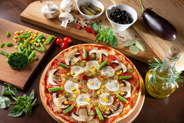appetizing pizza on a dark table with ingredients