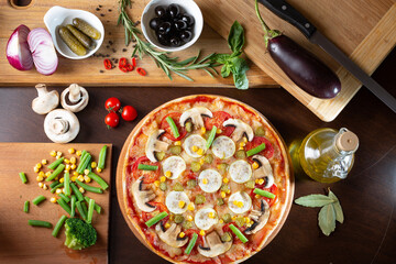 appetizing pizza on a dark table with ingredients