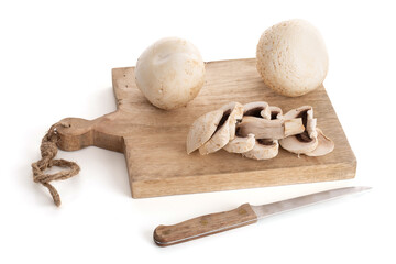 Fototapeta na wymiar White button mushroom (Agaricus Bisporus) on a cutting board