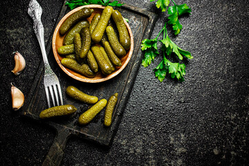 Pickles cucumber on a cutting board. 