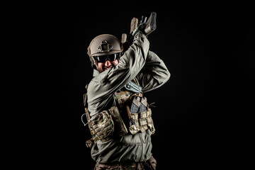 American special forces, a soldier in a military uniform with a weapon attacks on a black background, a ranger for special operations