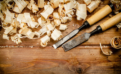 Chisels with wood chips on the table. 