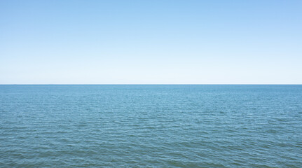 Fototapeta premium Horizon line, blue sky and blue sea. Drone view