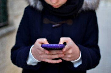 Hands of young girl holding a phone